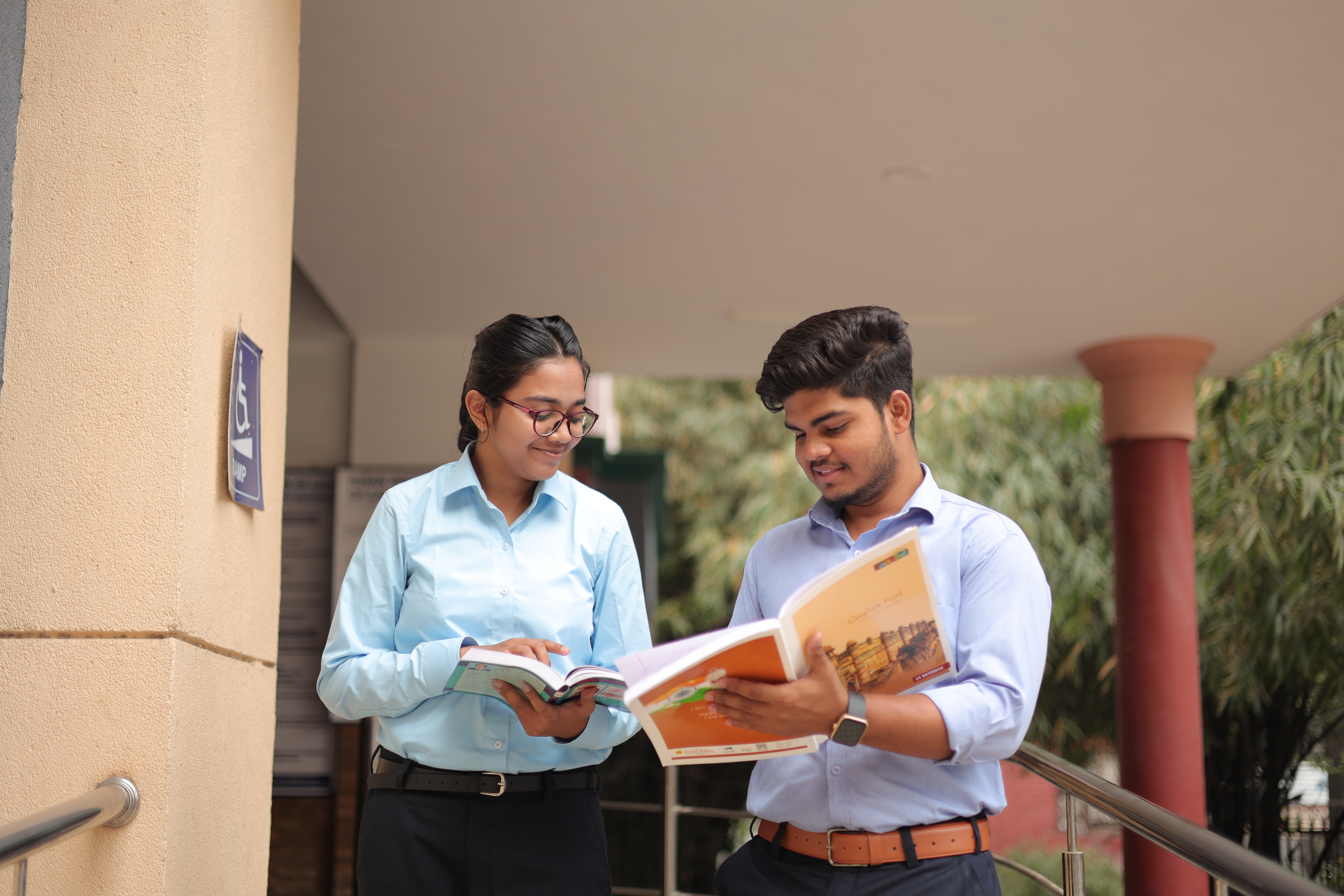 Top M Com Ishan IIMT Greater Noida students enhancing knowledge through teamwork.